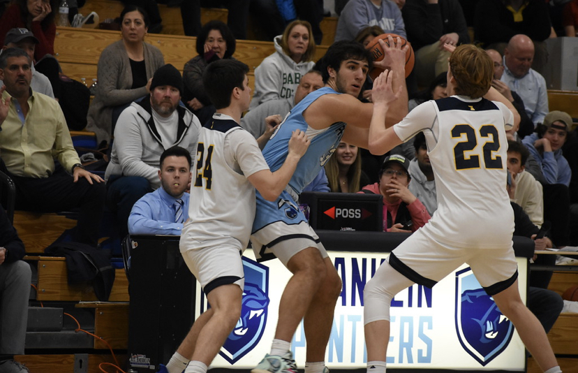 Franklin senior captain Ben Harvey (middle) holds the ball while being double teamed against Xaverian
