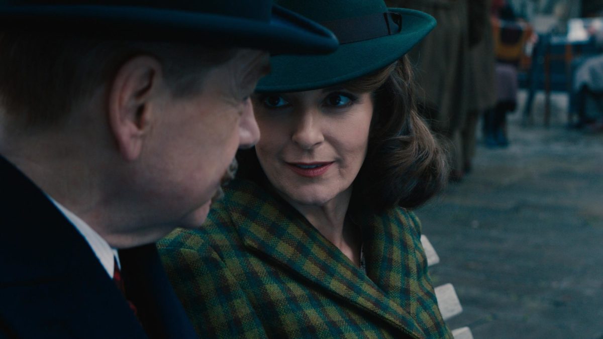 Hercule Poirot (Kenneth Branagh) catches up with Ariadne Oliver (Tina Fey), a close friend of his. Accessed as part of the A Haunting in Venice UK Press Kit.